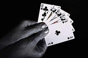 Playing cards in the silver male hands Playing cards in the silver male hands