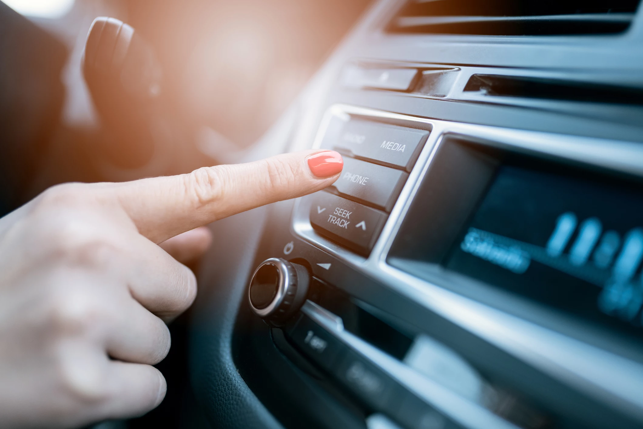 Woman pressing phone control button