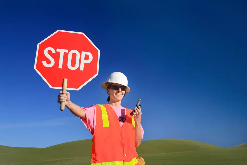 Woman Construction Worker with Stop Sign